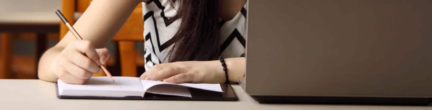 Female Studying At Her Desk Stock Photo