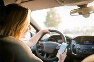 Teenage Female Texting While Driving Stock Photo