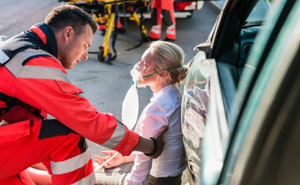 A woman being medically evaluated after a car accident.