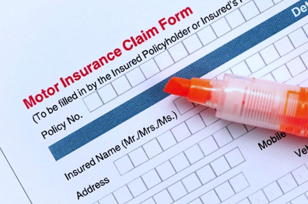 Closeup of orange highlighter on car insurance claim form.