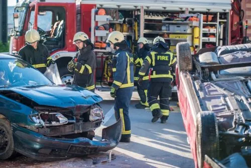 Firefighters check on injured driver after T-bone collision and rollover in Alabama.