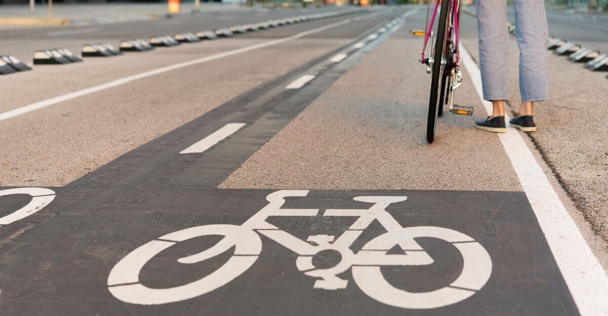 Wetumpka woman stands next to bicycle on edge of bike lane
