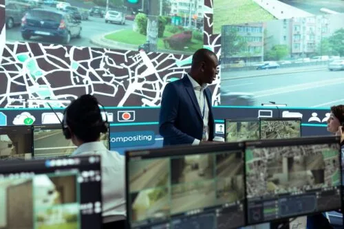 Transportation workers monitor vehicle data and maintenance calls from a remote dispatch center.